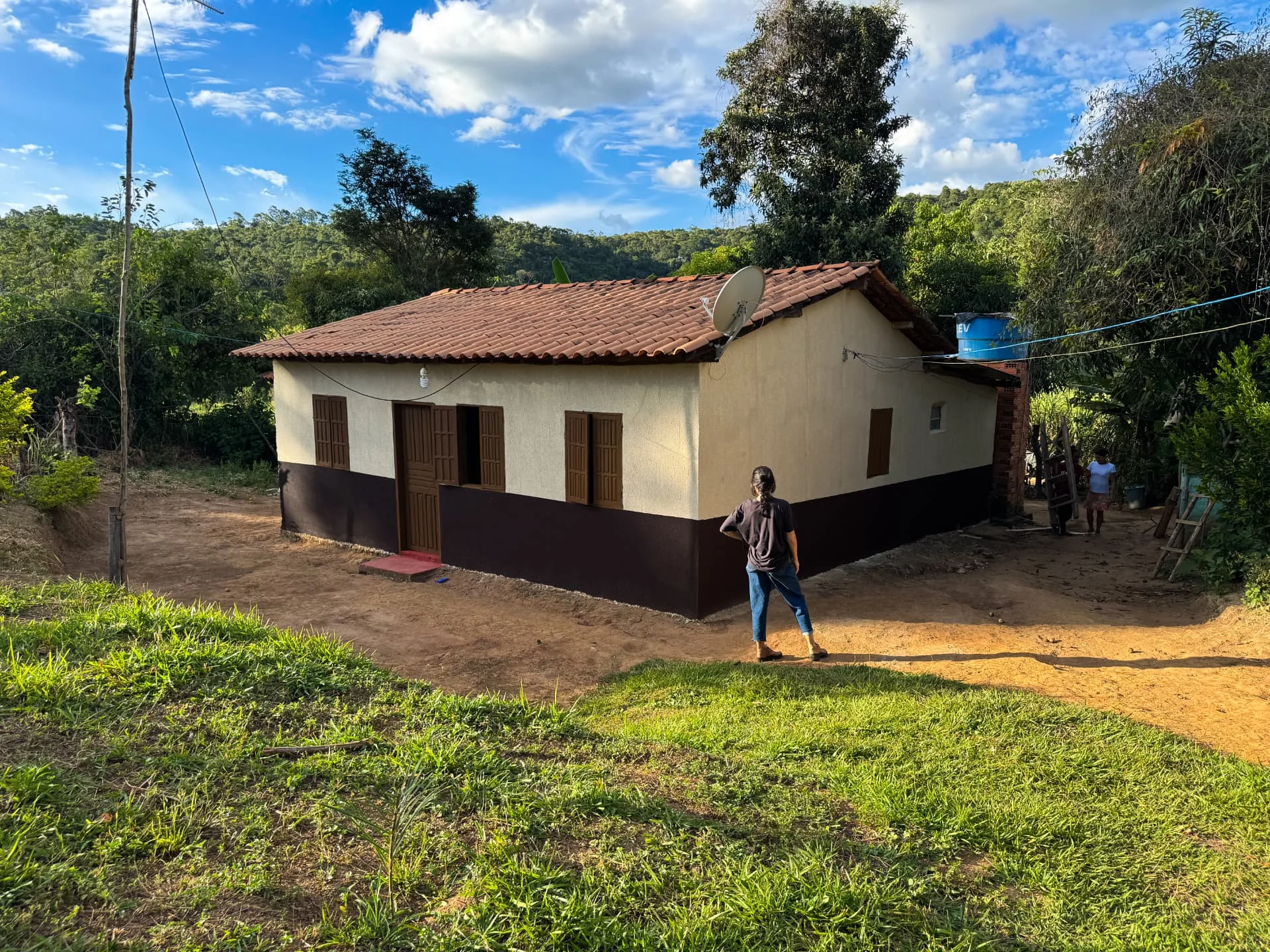 Casa da Vila Mumbuca pintada em creme e marrom, cercada pela mata